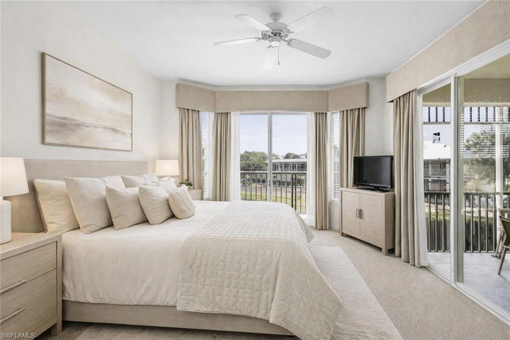 7910 Mahogany Run Lane, Unit 1225 Naples, FL 34113 - Photo 17 of 48 Virtual staged bedroom featuring access to exterior, light carpet, and ceiling fan
