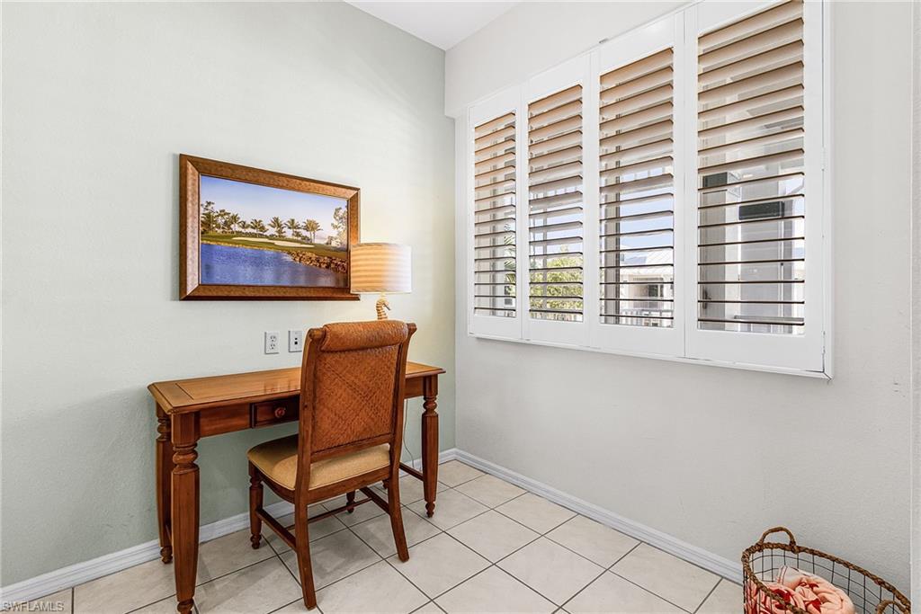 7910 Mahogany Run Lane, Unit 1225 Naples, FL 34113 - Photo 18 of 42 a chair and a table in a room