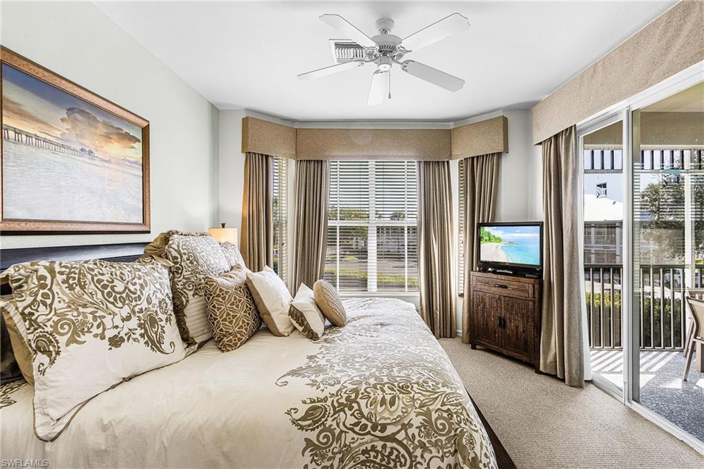 7910 Mahogany Run Lane, Unit 1225 Naples, FL 34113 - Photo 18 of 48 a bed sitting in a spacious bedroom next to a window