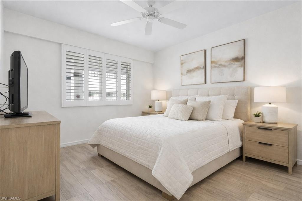 7910 Mahogany Run Lane, Unit 1225 Naples, FL 34113 - Photo 23 of 48 a bedroom with bed and a flat tv screen on a dresser