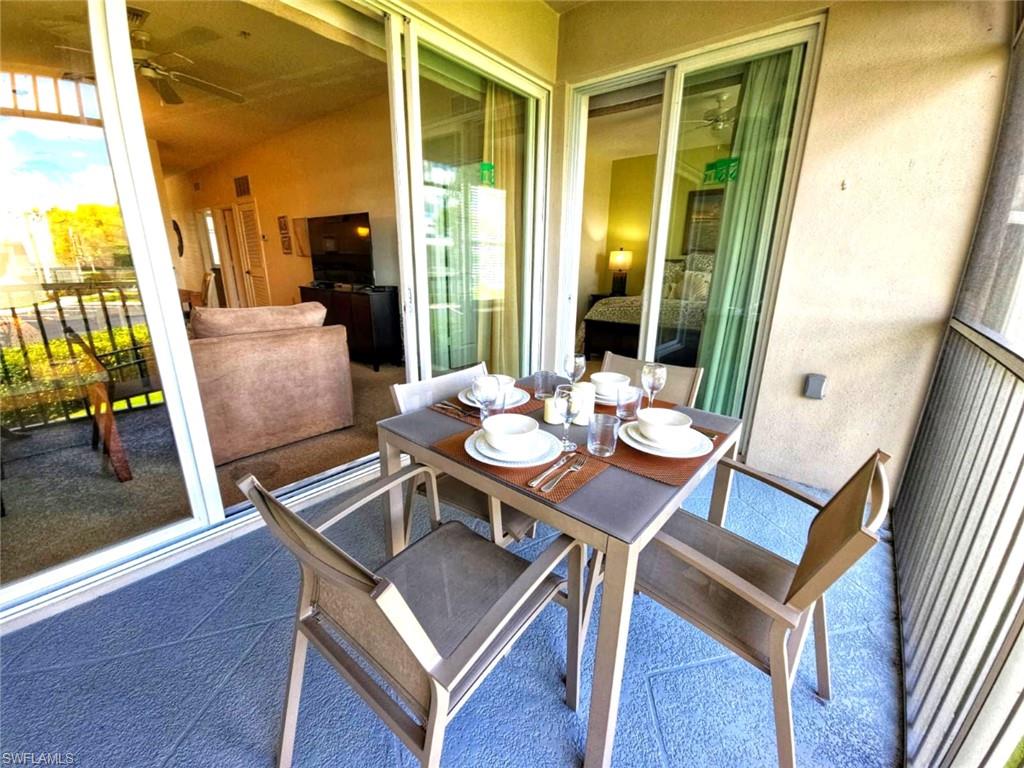 7910 Mahogany Run Lane, Unit 1225 Naples, FL 34113 - Photo 30 of 48 a view of a dining room with furniture window and wooden floor