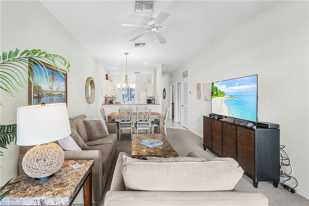 7910 Mahogany Run Lane, Unit 1225 Naples, FL 34113 - Photo 3 of 42 a living room with furniture and wooden floor