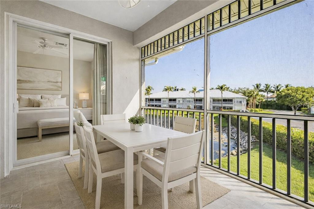 7910 Mahogany Run Lane, Unit 1225 Naples, FL 34113 - Photo 33 of 48 a view of a balcony dining table and chairs