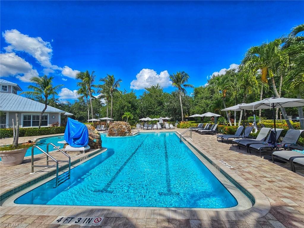 7910 Mahogany Run Lane, Unit 1225 Naples, FL 34113 - Photo 43 of 48 a view of a swimming pool with a lounge chairs