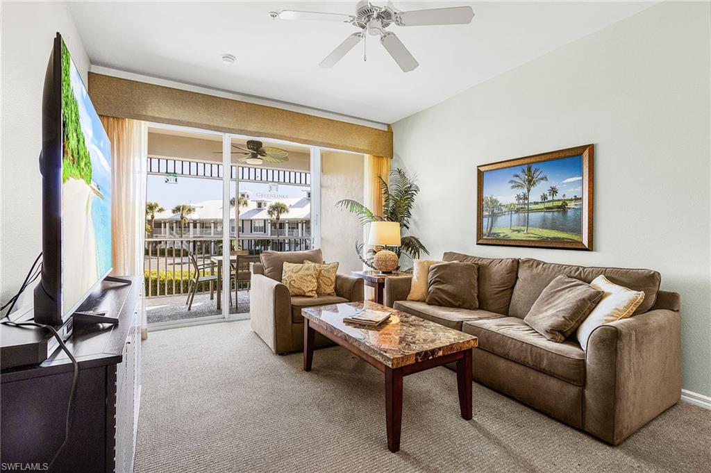 7910 Mahogany Run Lane, Unit 1225 Naples, FL 34113 - Photo 5 of 42 a living room with furniture and a large window