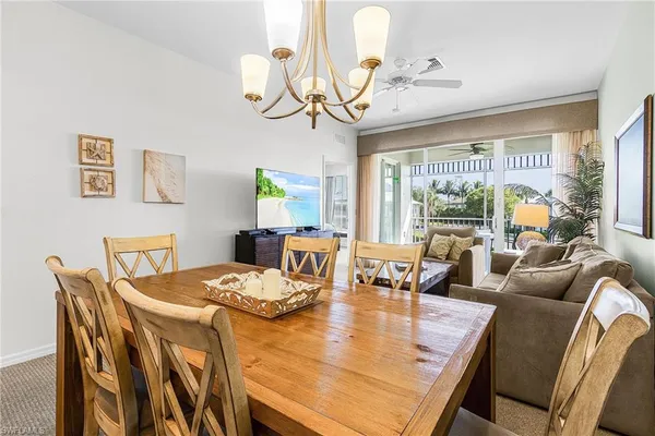 a view of a dining room with furniture wooden floor and chandelier