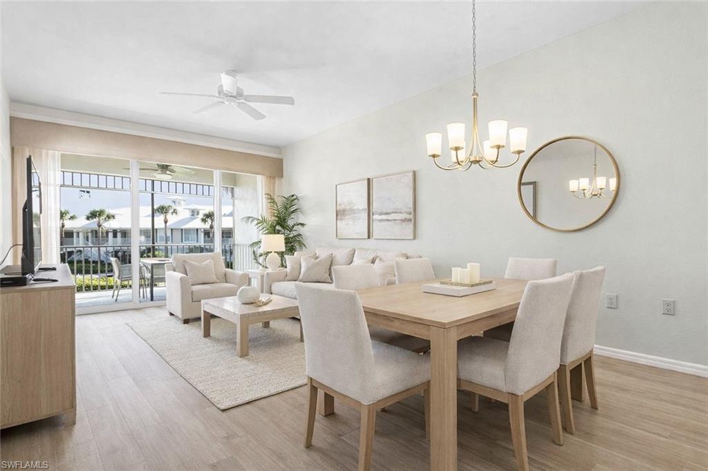 7910 Mahogany Run Lane, Unit 1225 Naples, FL 34113 - Photo 7 of 48 a view of a dining room with furniture wooden floor and chandelier