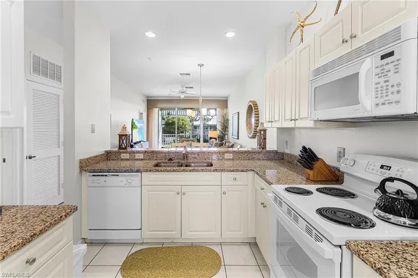 a kitchen with stainless steel appliances granite countertop a sink and cabinets