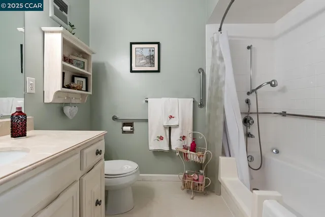 a bathroom with a sink toilet vanity and tub