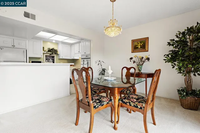 a view of a dining room with furniture and chandelier
