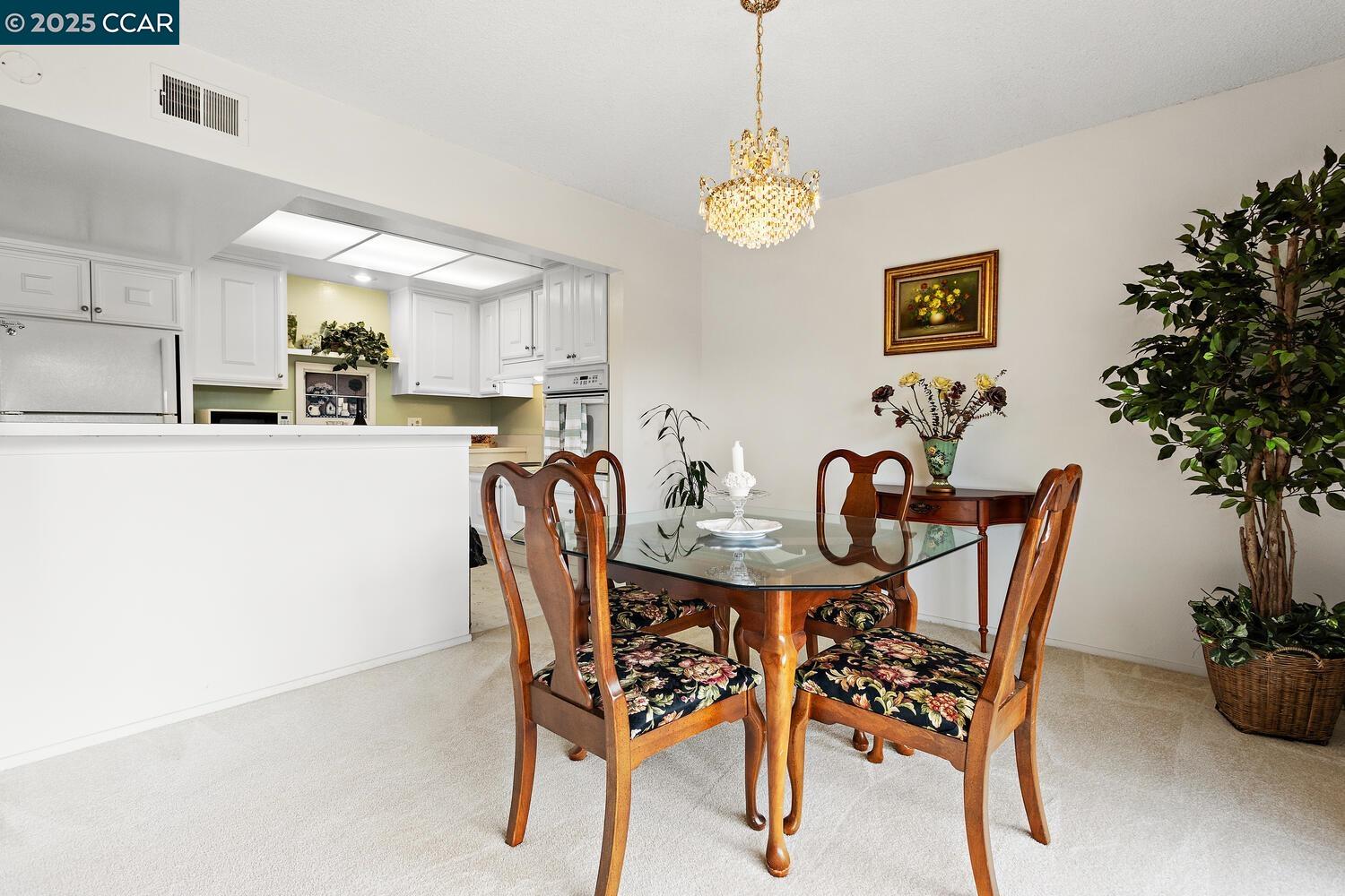 2709 Golden Rain Road, Unit 6 Walnut Creek, CA 94595 - Photo 6 of 46 a view of a dining room with furniture and chandelier