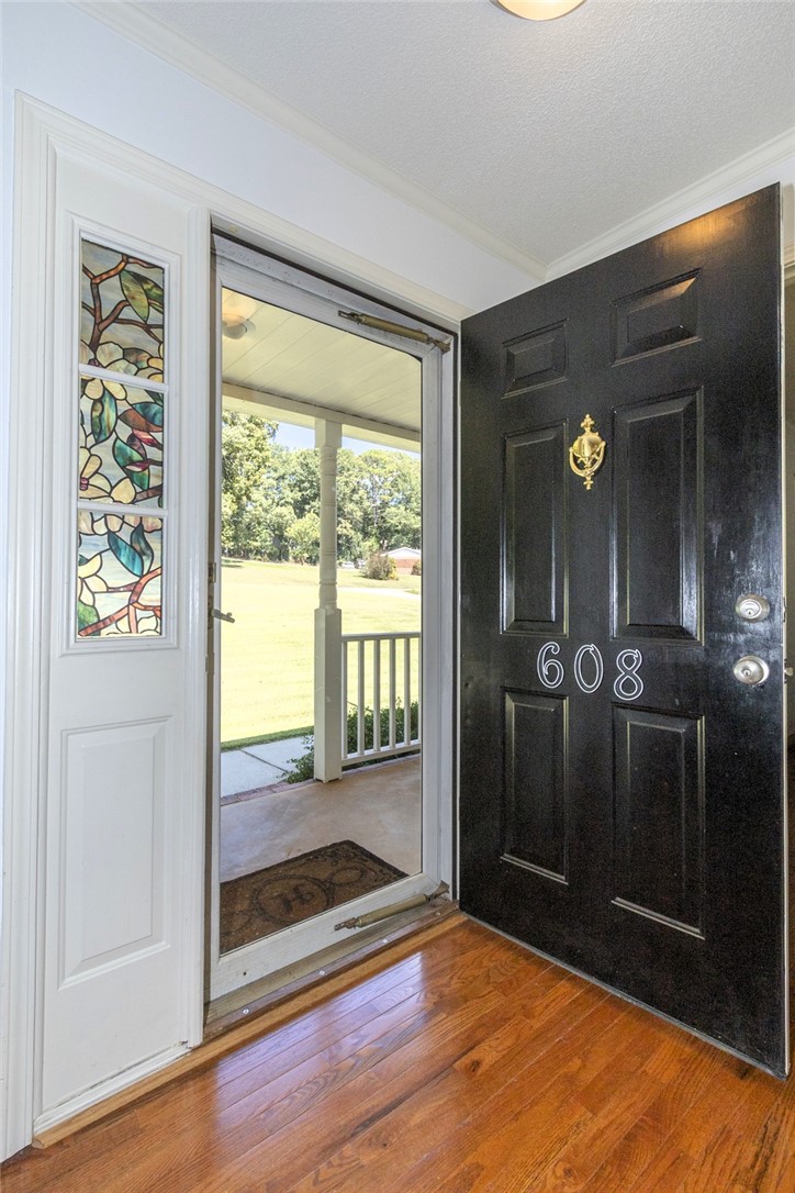 Gleaming hardwood floors and a decorative stained glass sidelight accent this inviting entryway.