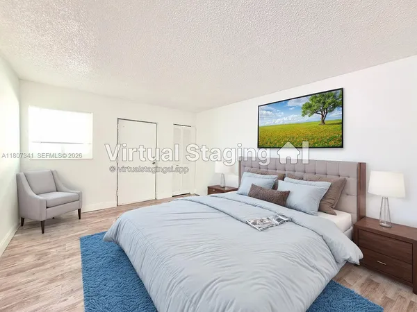 a bedroom with a large bed and a flat screen tv