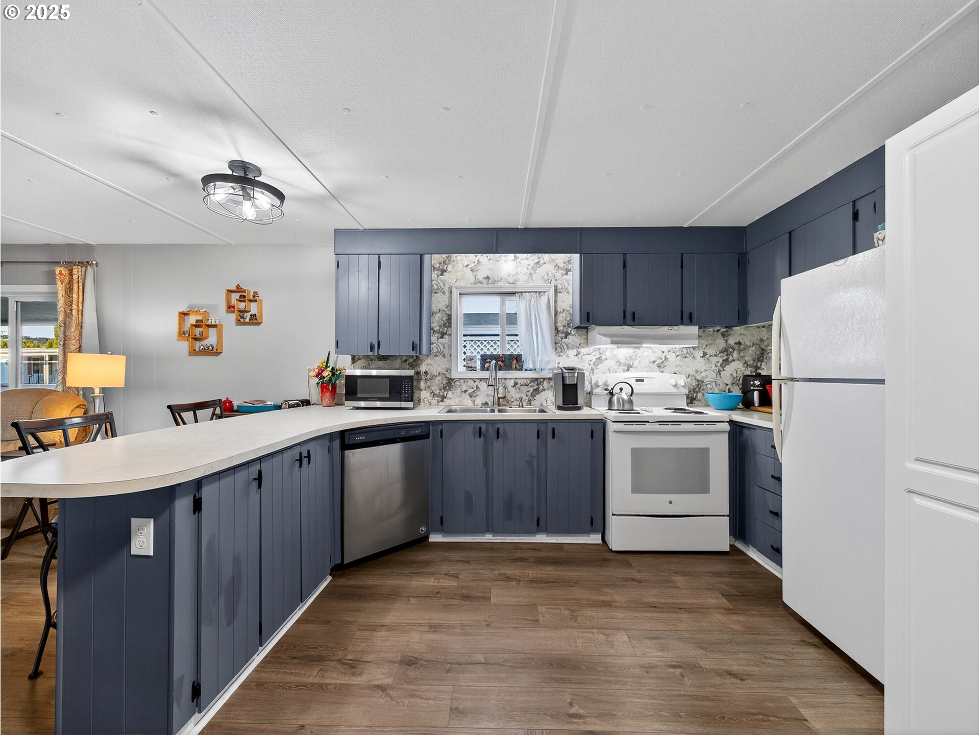 2902 East 2nd Street, Unit 54 Newberg, OR 97132 - Photo 15 of 32 a kitchen with a refrigerator and white cabinets