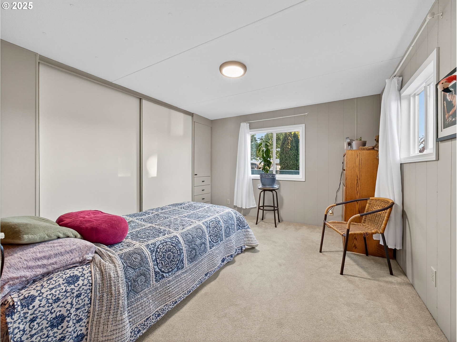 2902 East 2nd Street, Unit 54 Newberg, OR 97132 - Photo 18 of 32 a bedroom with a bed and a window