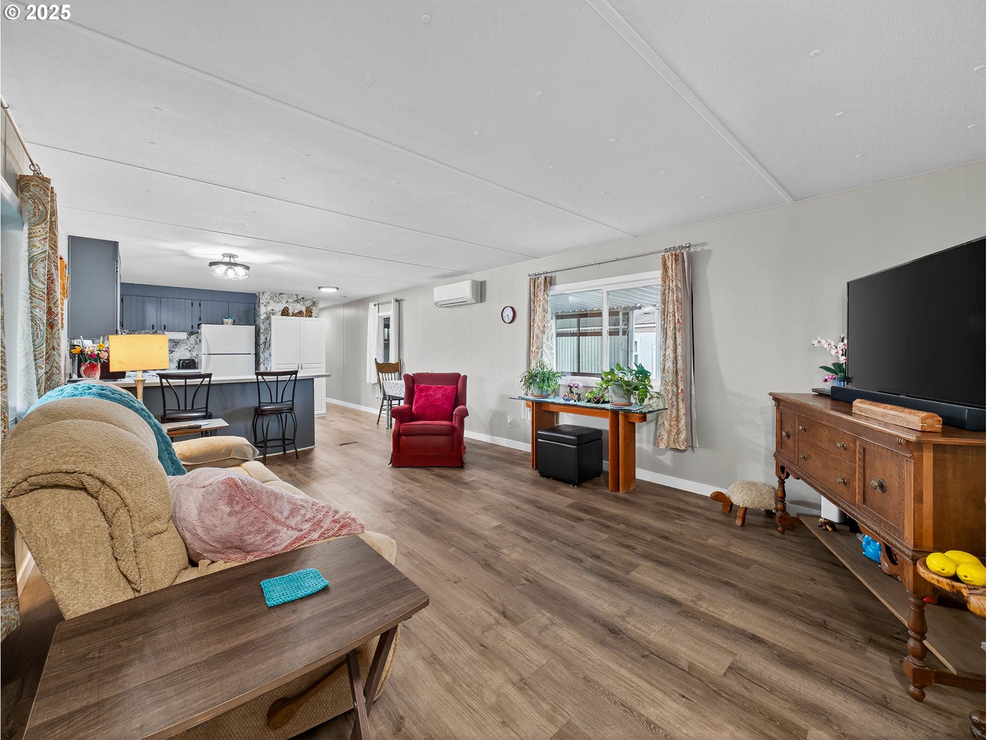 2902 East 2nd Street, Unit 54 Newberg, OR 97132 - Photo 9 of 32 a living room with furniture and a flat screen tv