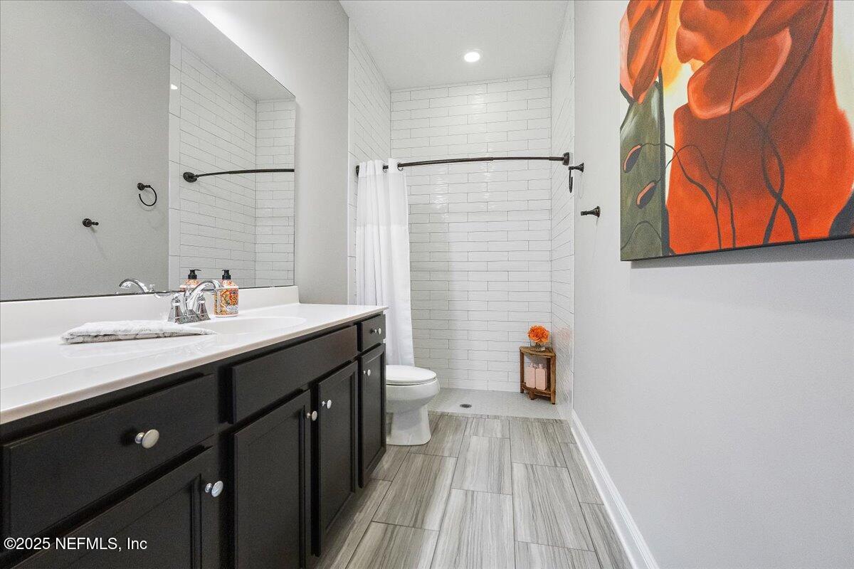 80 Greenview Lane St. Augustine, FL 32092 - Photo 16 of 37 a bathroom with a sink a toilet and shower