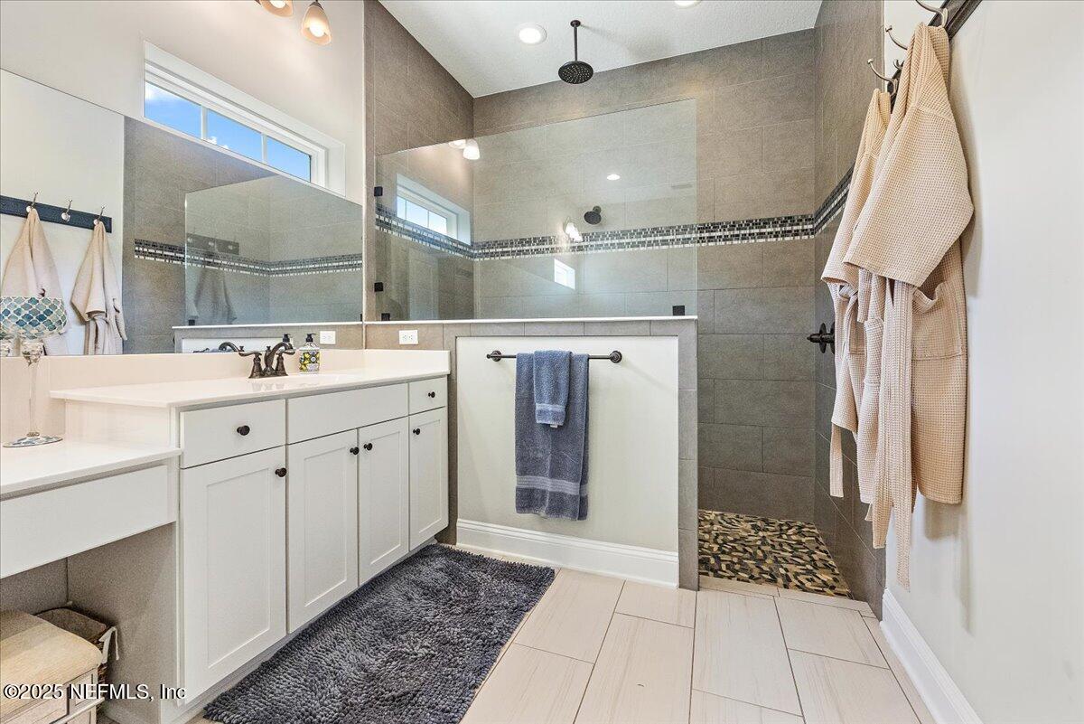 80 Greenview Lane St. Augustine, FL 32092 - Photo 20 of 37 a spacious bathroom with a shower sink and mirror