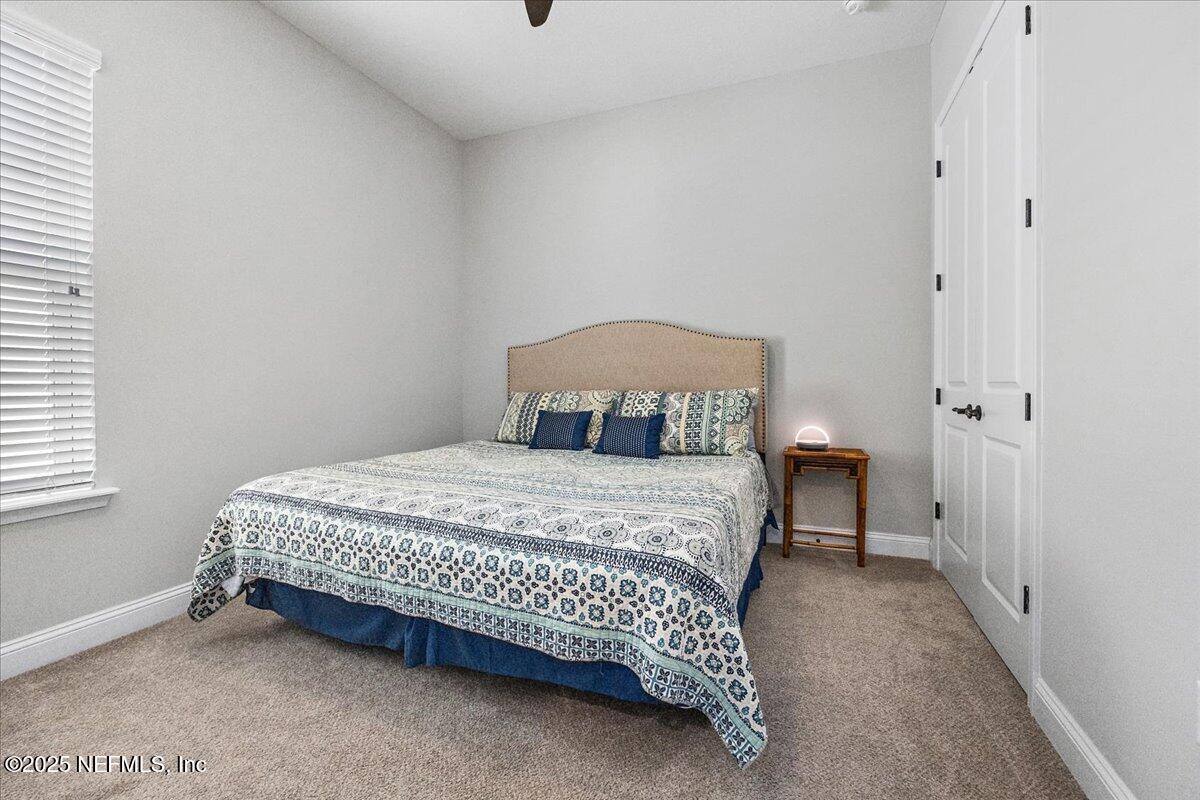 80 Greenview Lane St. Augustine, FL 32092 - Photo 23 of 37 a bedroom with a bed and a window