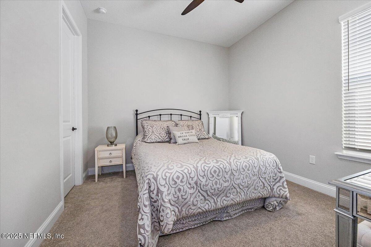 80 Greenview Lane St. Augustine, FL 32092 - Photo 25 of 37 a bedroom with a bed and window