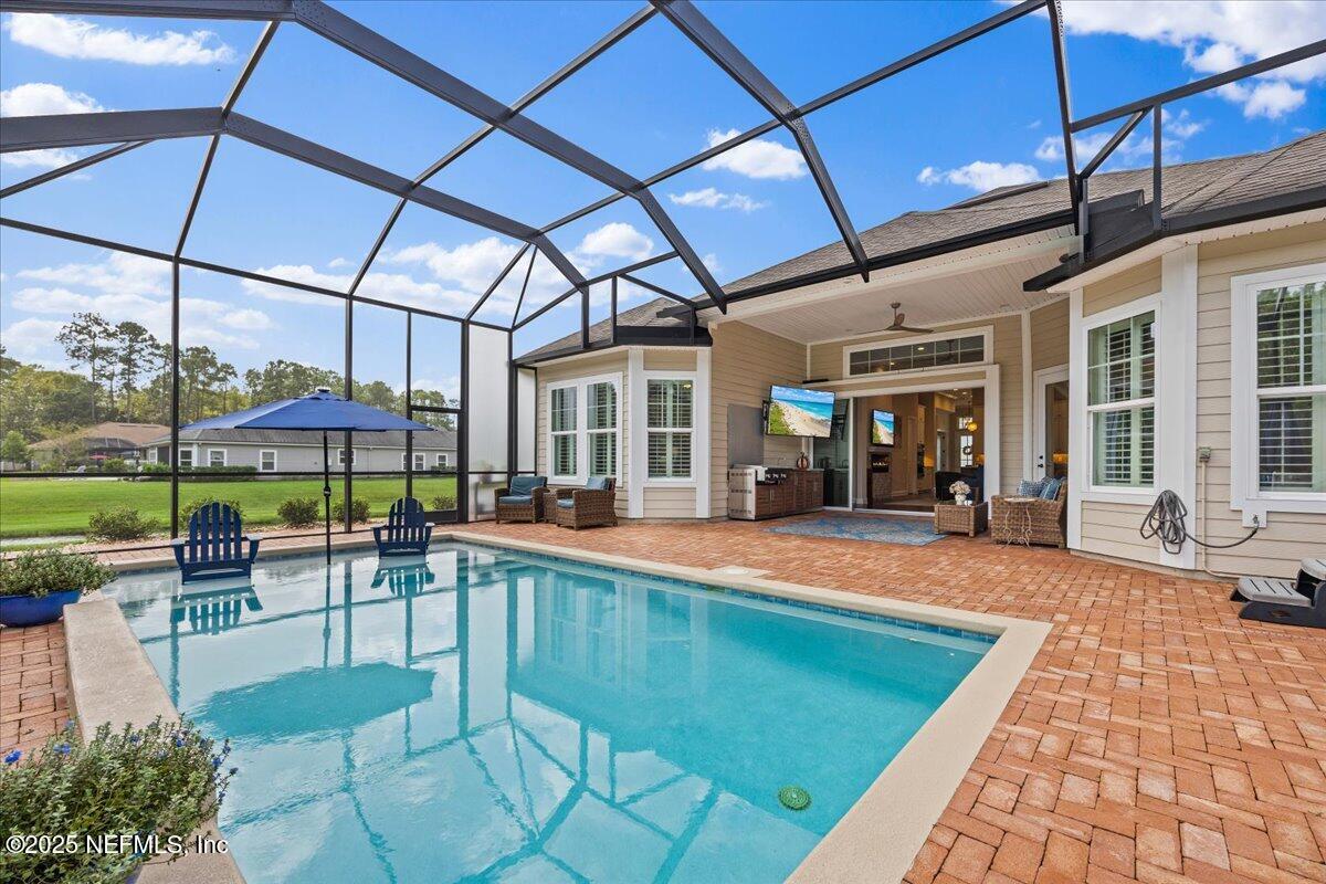 80 Greenview Lane St. Augustine, FL 32092 - Photo 30 of 37 a view of a patio with a table and chairs under an umbrella