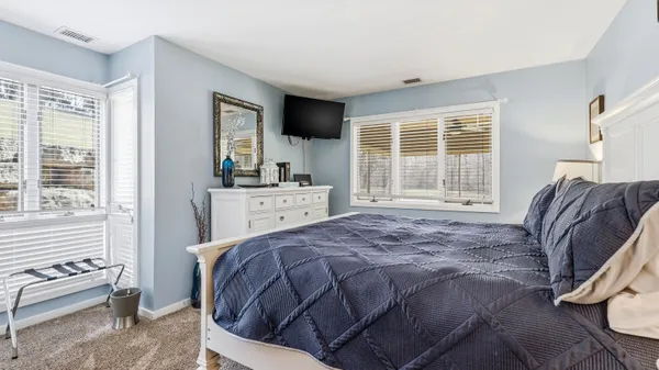 a bedroom with a bed and flat screen tv