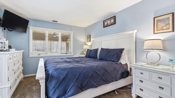 a large bed in a white room