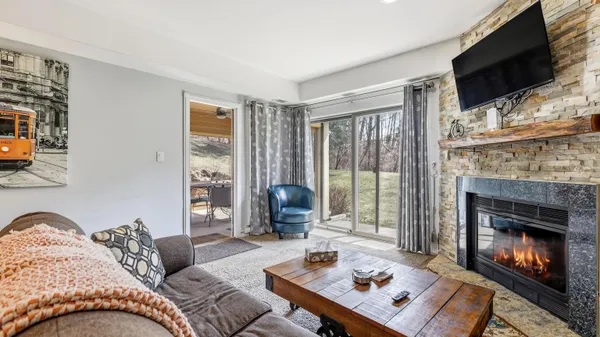 a living room with furniture fireplace and flat screen tv