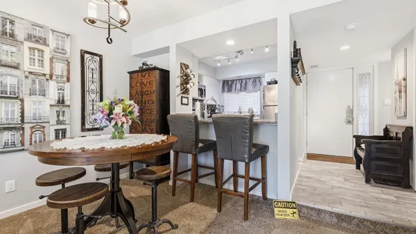 a view of a dining room with furniture and chandelier