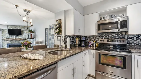 a kitchen with granite countertop a stove and a sink