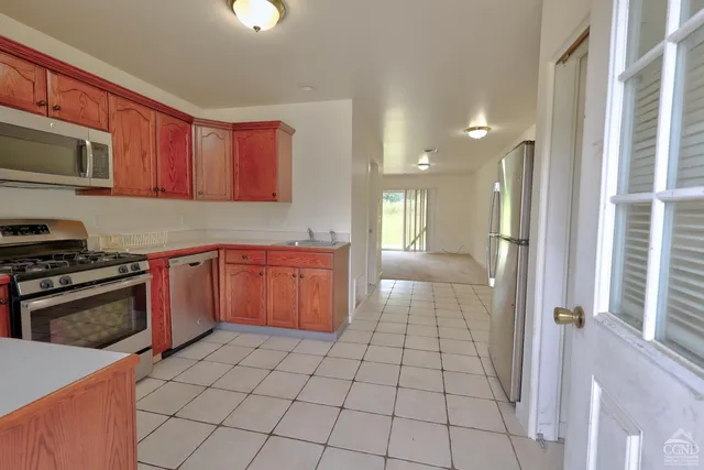 a kitchen with a stove sink and cabinets
