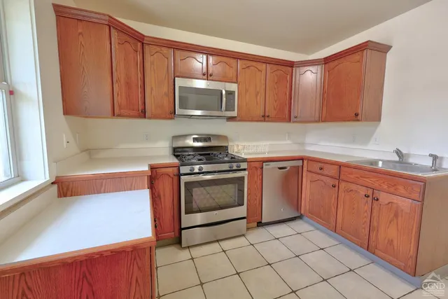a view of a spacious bathroom with a toilet and a shower