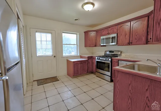a bathroom with a granite countertop toilet and a sink
