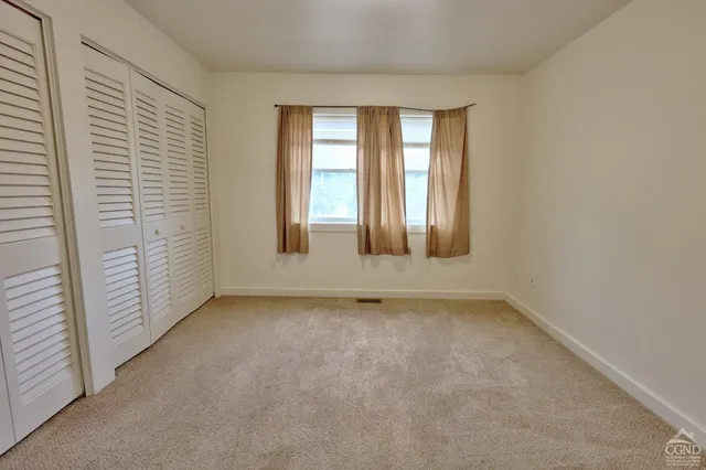 a front view of a house with a yard table and chairs