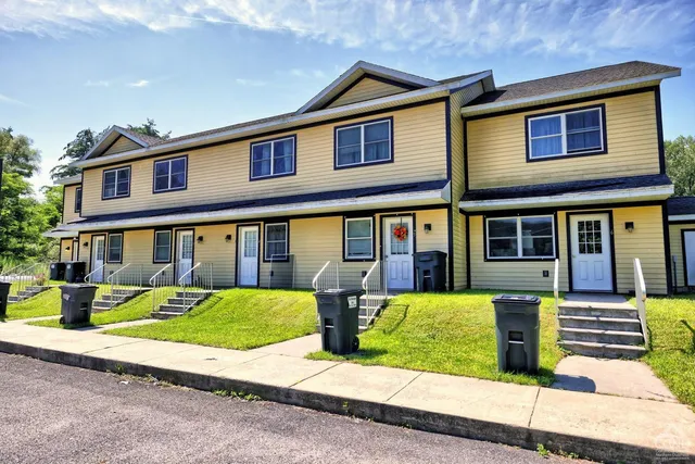 a view of a lush green field with mountains in the background