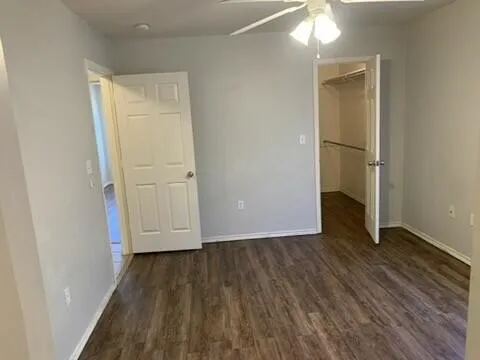an empty room with wooden floor and closet