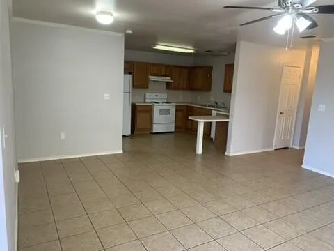 a kitchen with stainless steel appliances kitchen island granite countertop a sink and cabinets