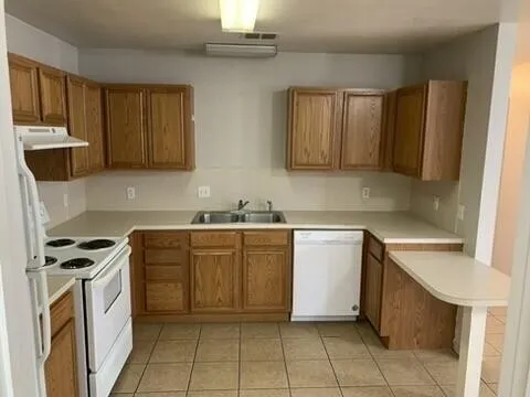 a kitchen with a stove sink and cabinets