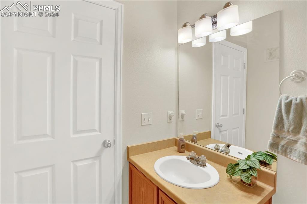 1776 Reilly Grove Colorado Springs, CO 80951 - Photo 11 of 21 a bathroom with a sink vanity and a mirror
