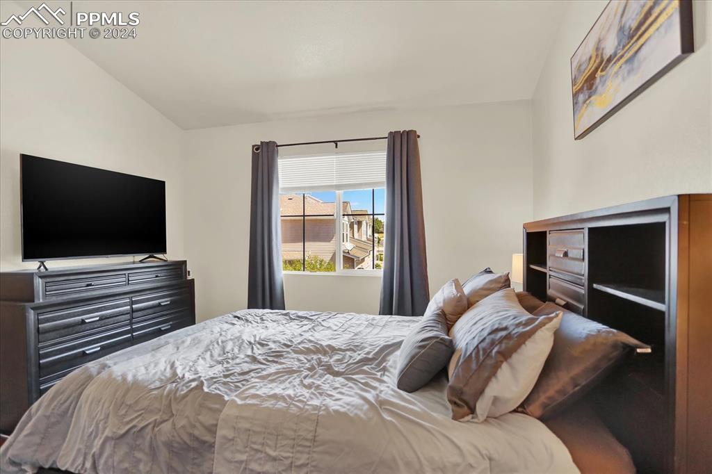 1776 Reilly Grove Colorado Springs, CO 80951 - Photo 13 of 21 a bedroom with a bed and a flat screen tv