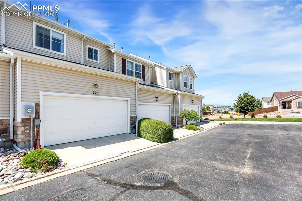 1776 Reilly Grove Colorado Springs, CO 80951 - Photo 20 of 21 a front view of a house with a yard and garage