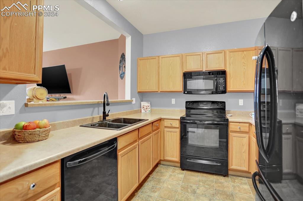 1776 Reilly Grove Colorado Springs, CO 80951 - Photo 8 of 21 a kitchen with stainless steel appliances granite countertop a sink stove and refrigerator