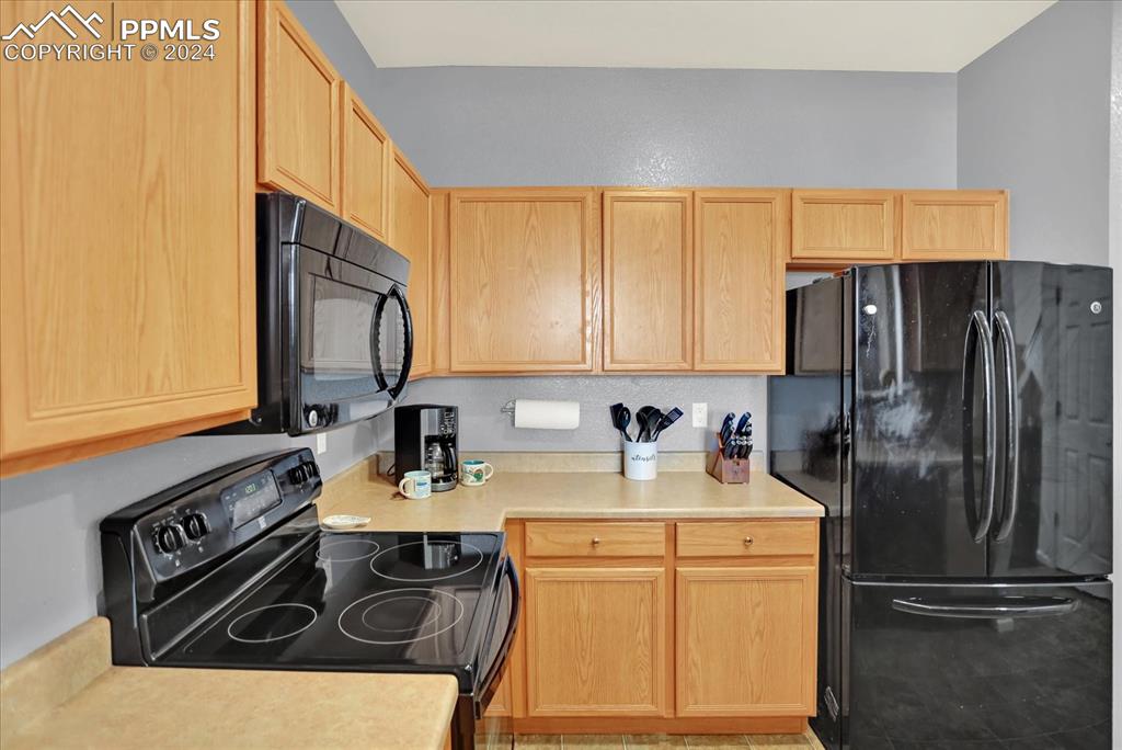 1776 Reilly Grove Colorado Springs, CO 80951 - Photo 10 of 21 a kitchen with a refrigerator stove and sink