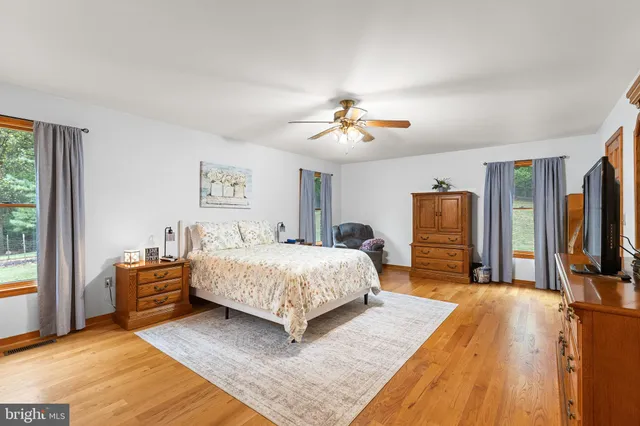 a spacious bedroom with a bed and a chandelier