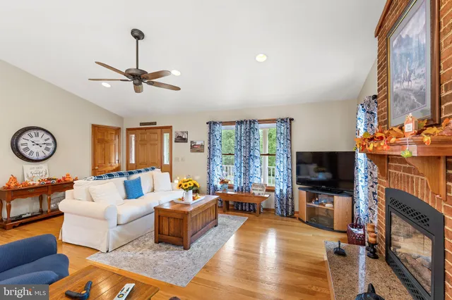 a living room with furniture a fireplace and a flat screen tv