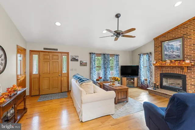 a living room with furniture a fireplace and a flat screen tv