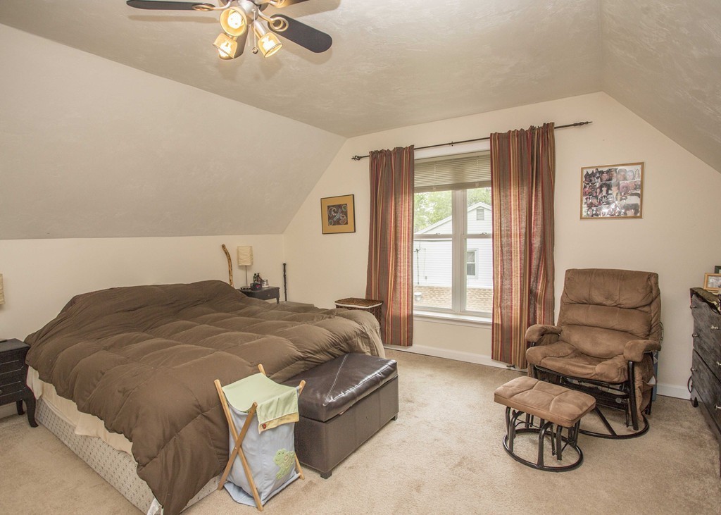 96 Park Road Charlton, MA 01507 - Photo 25 of 30 a spacious bedroom with a bed and a chair