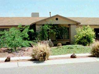 6867 North De Chelly Loop Tucson, AZ 85741 - Photo 1 of 1 a front view of a house with a yard