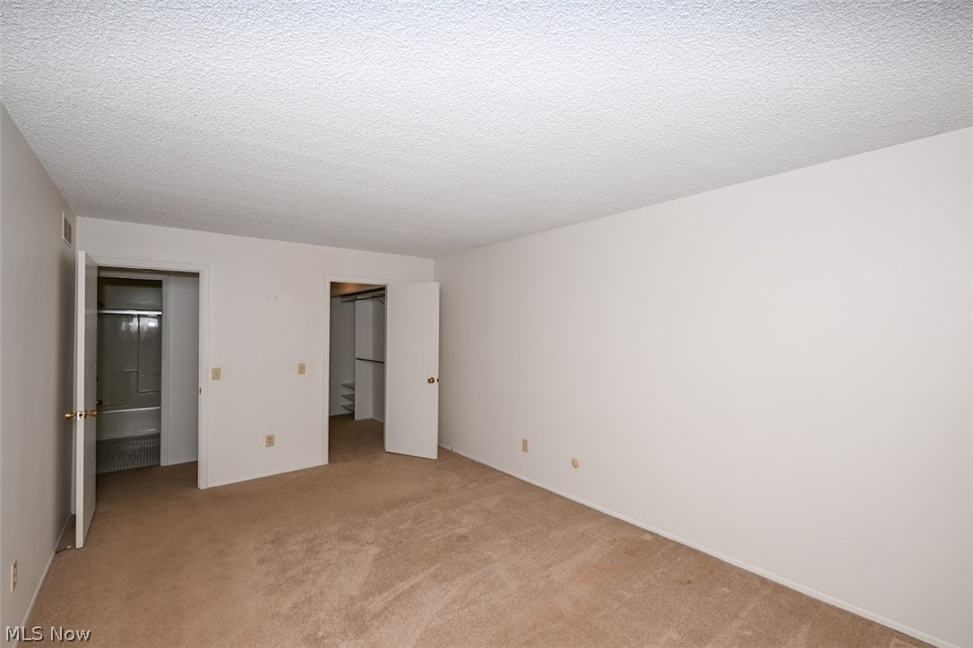 979 Hampton Ridge Drive Akron, OH 44313 - Photo 22 of 25 Unfurnished bedroom featuring a textured ceiling and carpet flooring