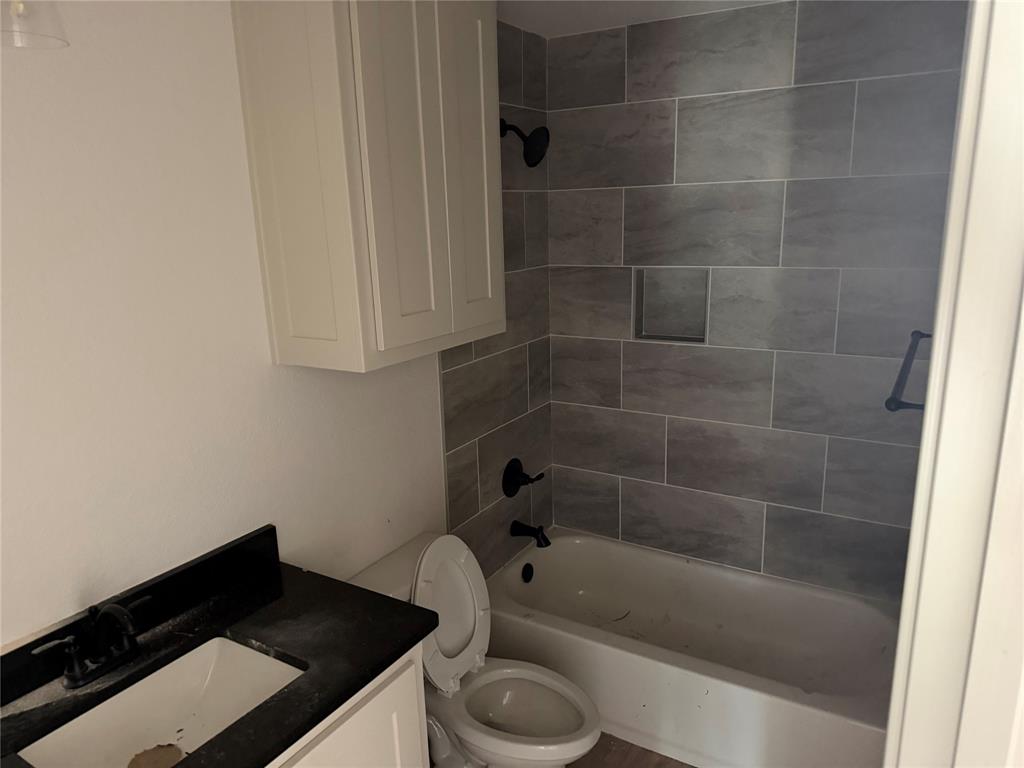 300 Myers Drive Springtown, TX 76082 - Photo 8 of 8 a bathroom with a granite countertop sink toilet and bathtub